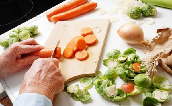 hands of a senior woman preparing vegetables for cooking, part of a series